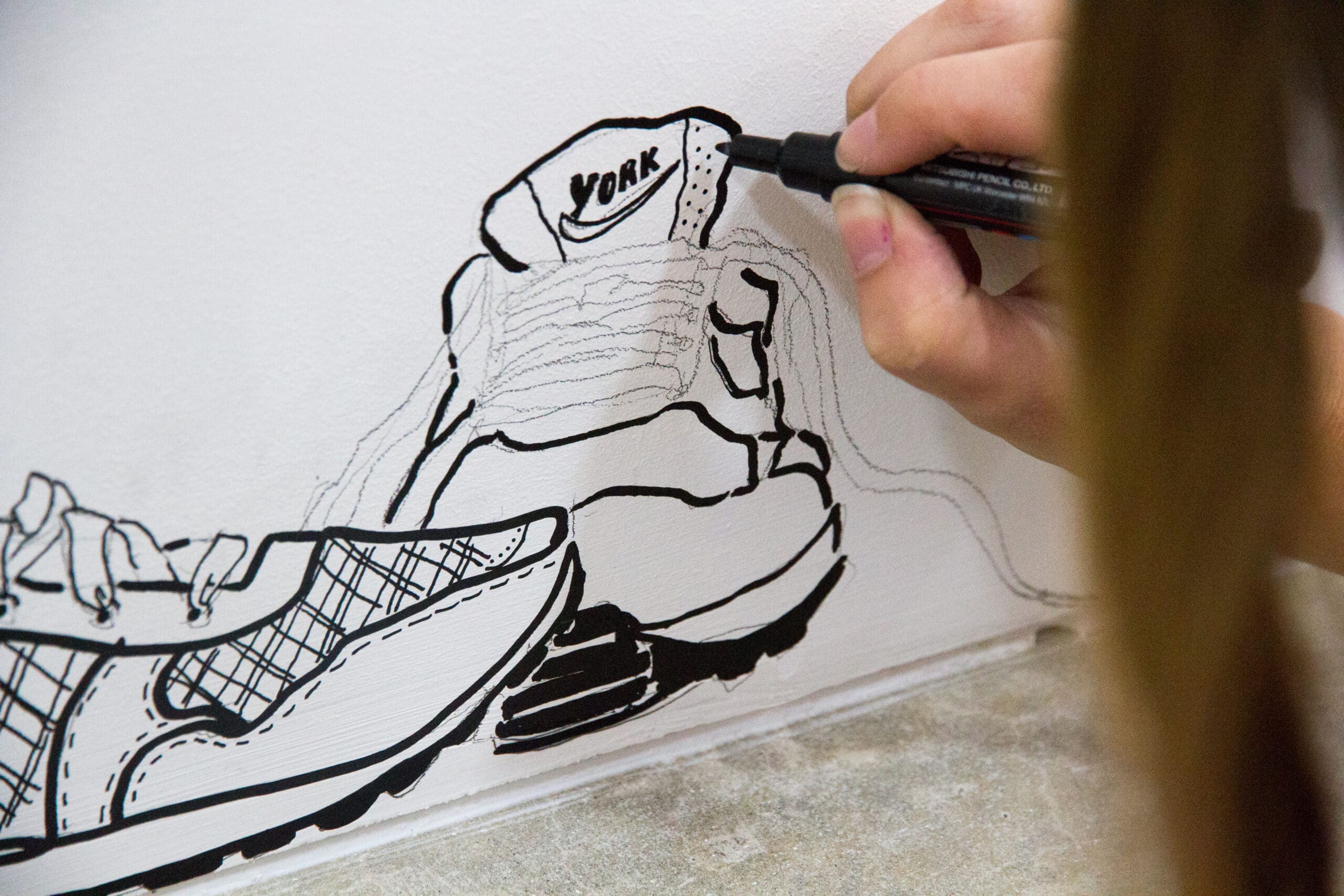drawing shoes on a wall mural