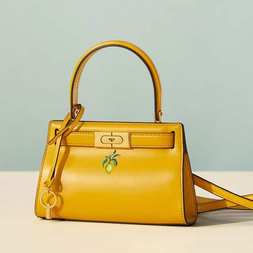 yellow leather bag with small hand painted illustration